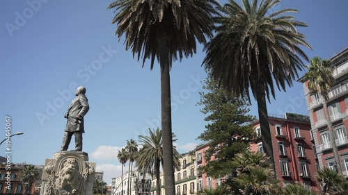 View of Giovanni Nicotera statue and colourful architecture in Piazza della Vittoria, Naples, Campania, Italy