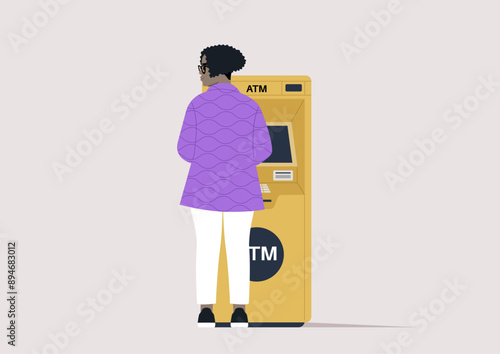 A rear view of a curly lady withdrawing money from an outdoor ATM machine