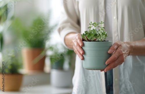 Woman Watering Plants on Table