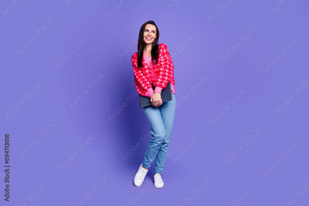 Full length photo of shiny attractive lady dressed pink cardigan holding modern device looking emtpy space isolated violet color background Full length photo of shiny attractive lady dressed pink cardigan holding modern device looking emtpy space isolated violet color background