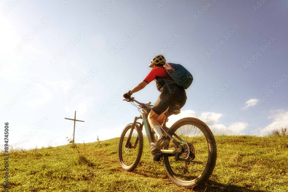nice active senior woman riding her electric mountain bike at Mount Huendle in Oberstaufen, Allgaeu Alps , Bavaria, Germany nice active senior woman riding her electric mountain bike at Mount Huendle in Oberstaufen, Allgaeu Alps , Bavaria, Germany