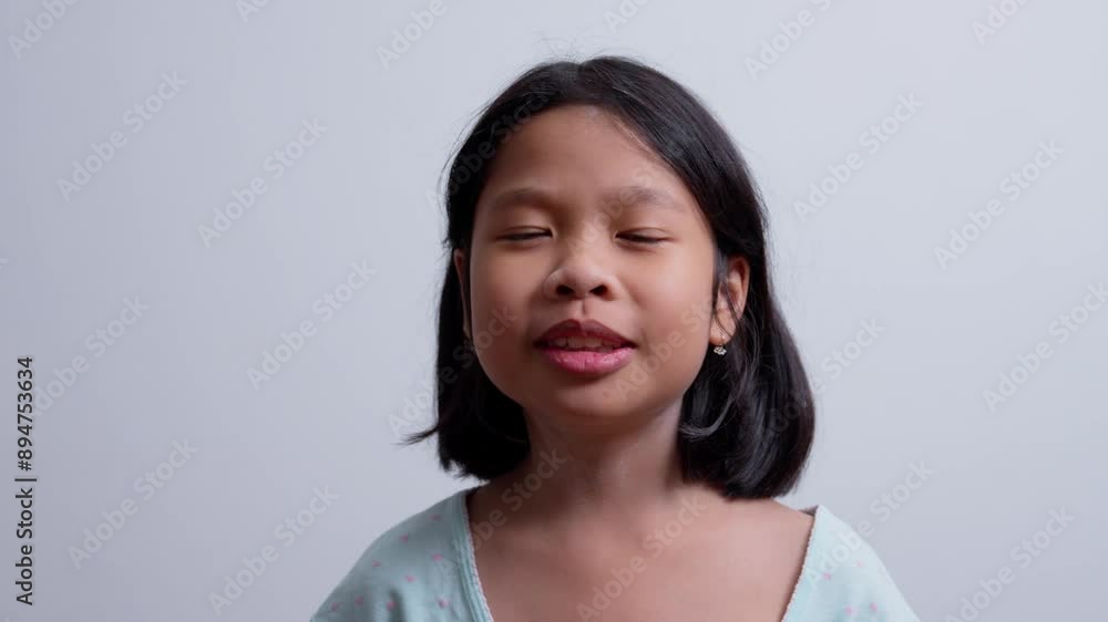 Portrait Funny little asian girl big smiling child looking at camera and pointing her cheeks, enjoying childhood testimonial concept, Positive child, 4k footage, Slow Motion Portrait Portrait Funny little asian girl big smiling child looking at camera and pointing her cheeks, enjoying childhood testimonial concept, Positive child, 4k footage, Slow Motion Portrait