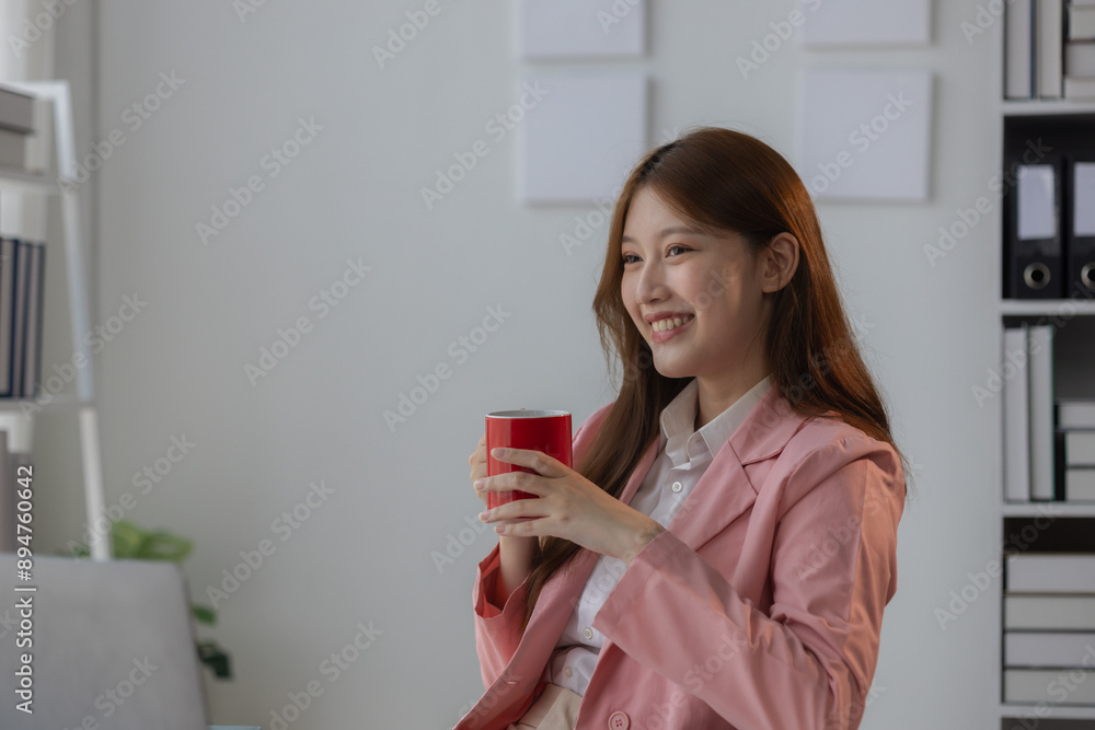 a businesswoman is showing smile on her face because she feels relax and cozy while take a rest in the office, a beautiful employee enjoy her free time in the workplace a businesswoman is showing smile on her face because she feels relax and cozy while take a rest in the office, a beautiful employee enjoy her free time in the workplace