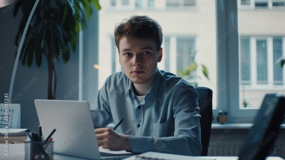 Man in office setting working on laptop Man in office setting working on laptop