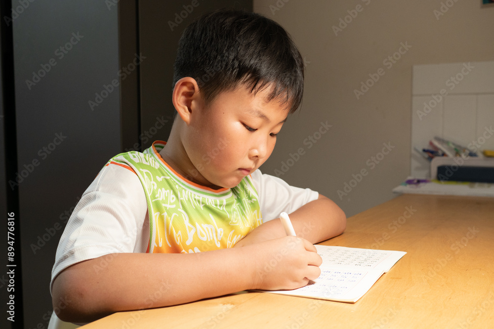An Asian child is writing Chinese characters An Asian child is writing Chinese characters