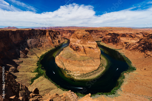 High angle and panoramic view of three motorboats sailing on Colorado River amid red rock cliff and canyon at Horseshoe Bend of Glen Canyon, Arizona, USA
 photo