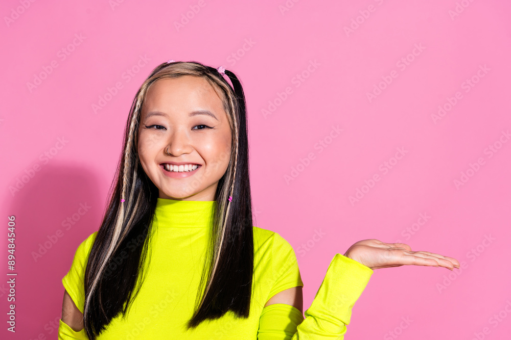 Photo of nice girl with dyed hairdo dressed yellow turtleneck palm demonstrate product empty space isolated on pink color background Photo of nice girl with dyed hairdo dressed yellow turtleneck palm demonstrate product empty space isolated on pink color background