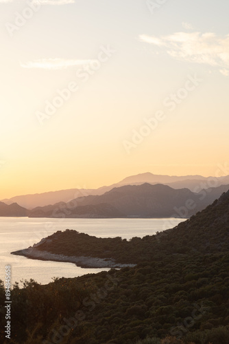 Sunset in the mountains with olive groves over the Mediterranean sea photo