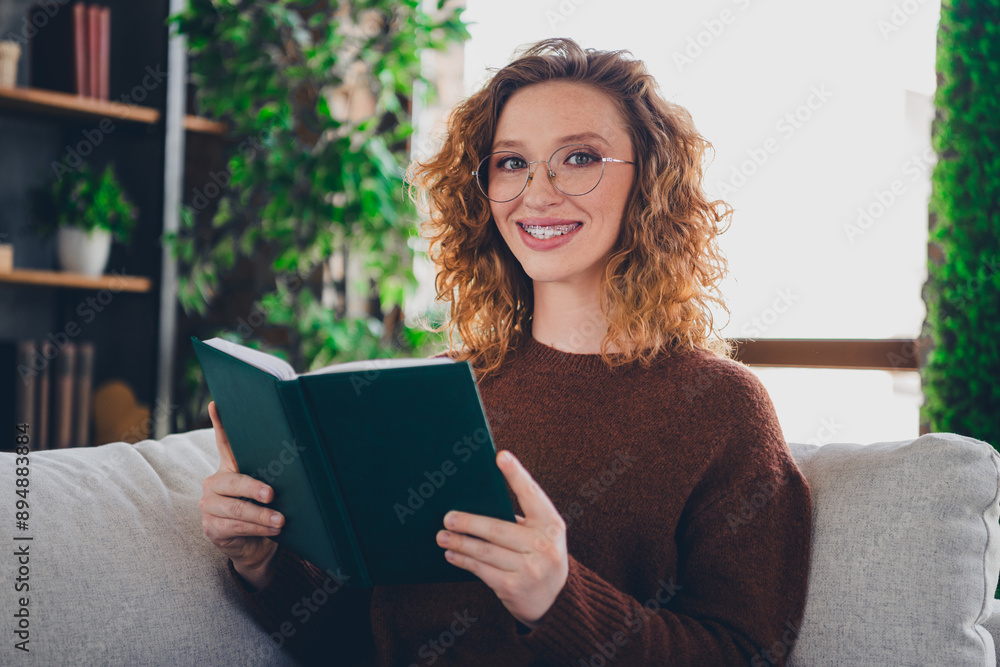 Photo of pretty cute adorable woman wear stylish clothes hold planner read text indoors house home Photo of pretty cute adorable woman wear stylish clothes hold planner read text indoors house home