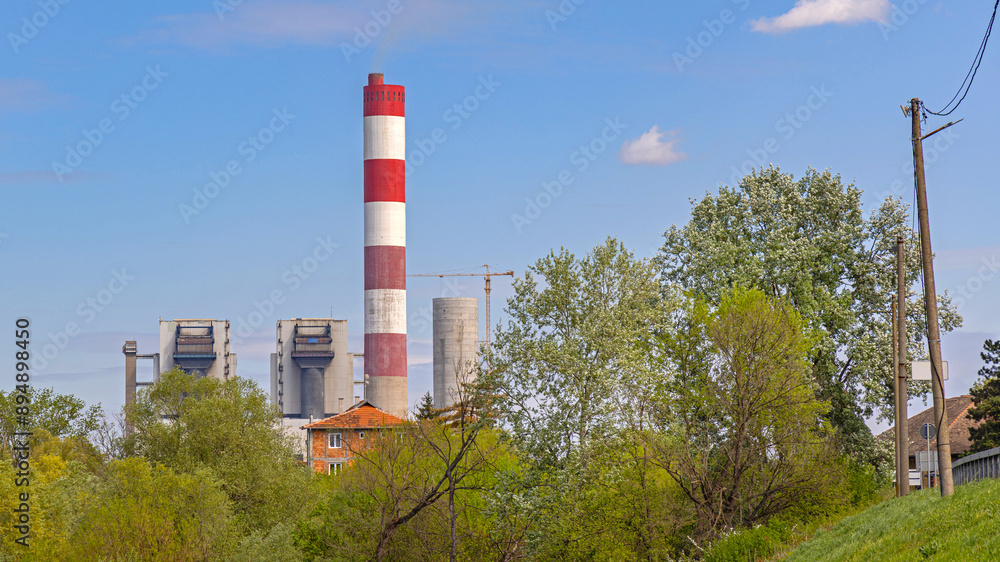 Red and White Chimney at Thermal Power Plant Facility Spring Day Blue Sky Red and White Chimney at Thermal Power Plant Facility Spring Day Blue Sky