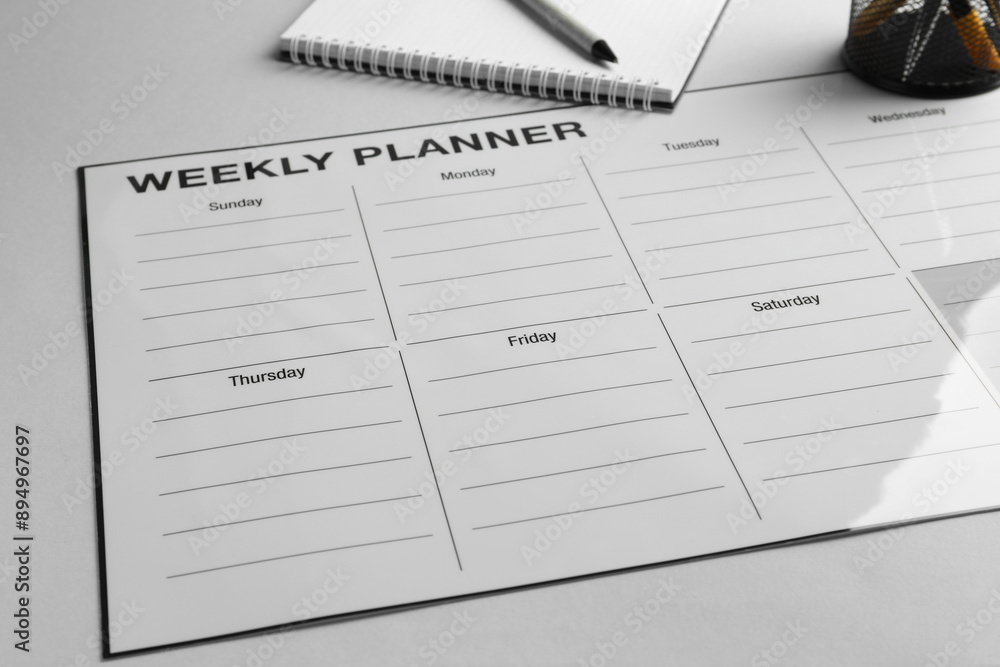 Timetable. Planner, notebook and pen on grey table, closeup Timetable. Planner, notebook and pen on grey table, closeup