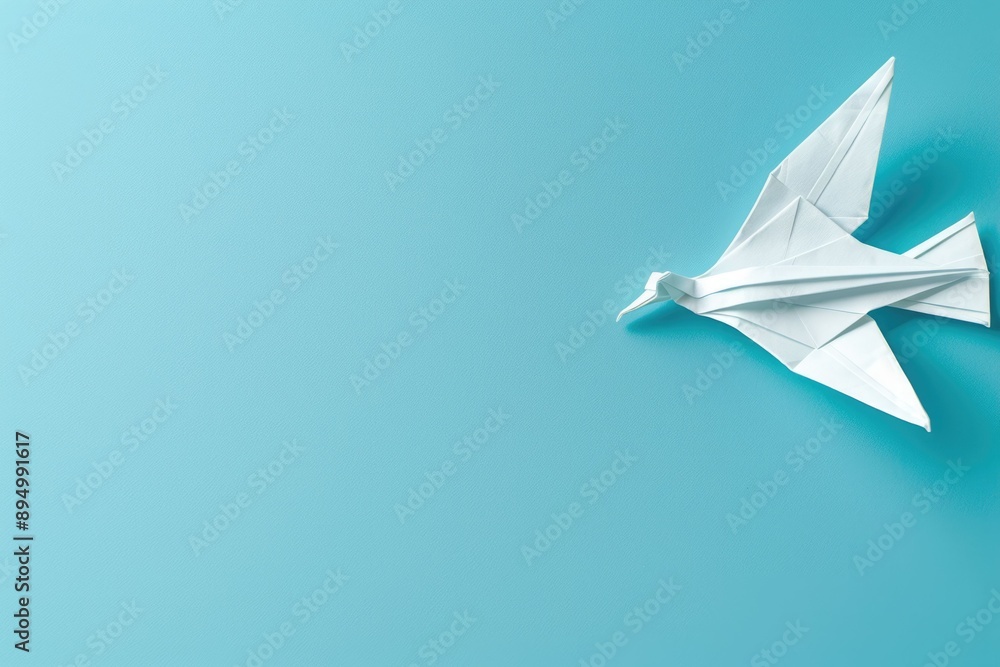 Origami pigeon symbolizing World Peace Day on blue background. Origami pigeon symbolizing World Peace Day on blue background.