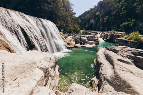 Beautiful waterfalls and cascades through a rocky landscape at Air Terjun Tanggedu, Indonesia; Ndapayami, Kanatang, East Sumba Regency, East Nusa Tenggara, Indonesia photo