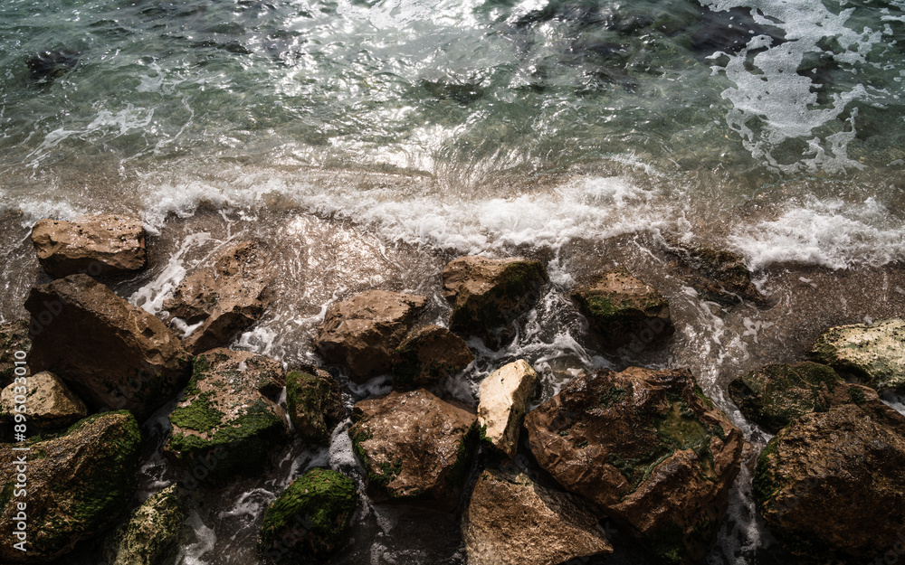 Water rushes in along smooth limestone along the Mediterranean coast