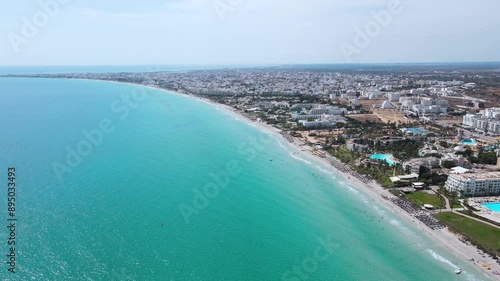 Wallpaper Mural The image is an aerial view of a beach with crystal blue water of a Hotel at Mahdia, where people are enjoying various activities. A few surfboards can also be seen floating on the water. Torontodigital.ca