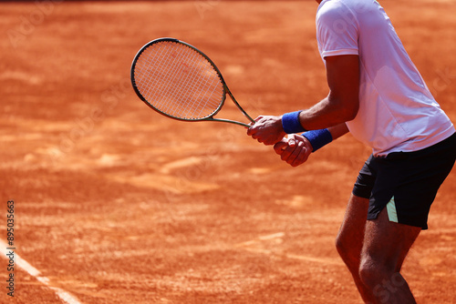 Tennis player, holding racket in position for ball reception
