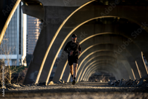 Mid 20s male trail running. photo