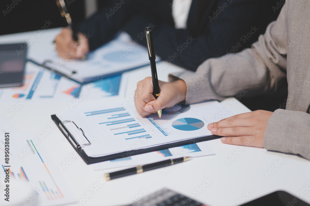 Close up of Business team analyzing income charts and graphs with modern laptop computer. Business analysis and strategy concept. Close up of Business team analyzing income charts and graphs with modern laptop computer. Business analysis and strategy concept.