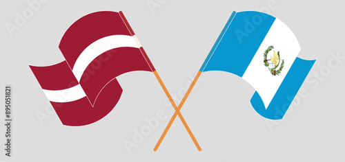 Crossed and waving flags of Latvia and Republic of Guatemala