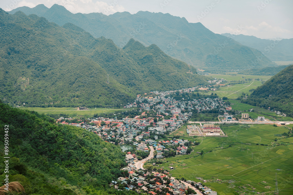 Town of Mai Chau and farmland in a valley, Vietnam; Mai Chau, Tong Tau, Mai Chau, Hoa Binh, Vietnam Town of Mai Chau and farmland in a valley, Vietnam; Mai Chau, Tong Tau, Mai Chau, Hoa Binh, Vietnam