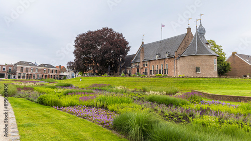 Beautiful park and garden with purple and blue flowers near the city hall and castle of Coevorden in Drenthe The Netherlands photo