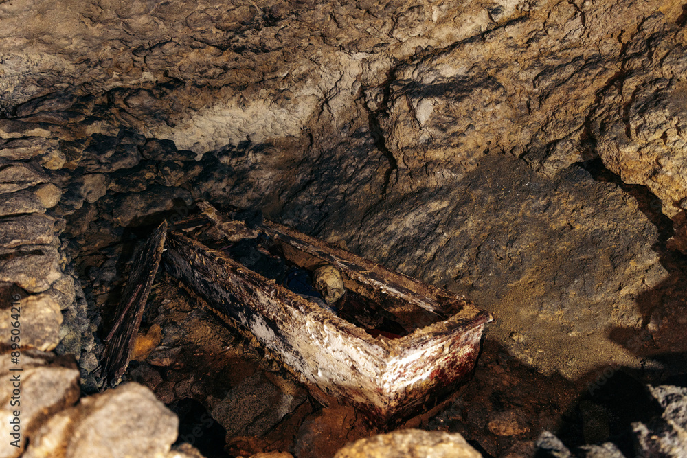 Coffin with bones in a cave at a burial site in the ancient village of Ke'te Kesu' in the Toraja Highlands, Indonesia; Ke'te' Kesu' Toraja, Rante Pao area, North Toraja, South Sulawesi, Indonesia Coffin with bones in a cave at a burial site in the ancient village of Ke'te Kesu' in the Toraja Highlands, Indonesia; Ke'te' Kesu' Toraja, Rante Pao area, North Toraja, South Sulawesi, Indonesia