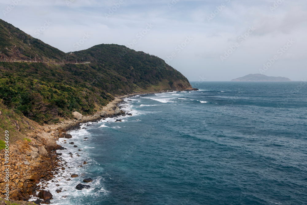 Beautiful coastline and surf at Chim Chim Cape, Con Dao archipelago in the South China Sea, Vietnam; Con Dao, Ba Ria - Vung Tau, Vietnam Beautiful coastline and surf at Chim Chim Cape, Con Dao archipelago in the South China Sea, Vietnam; Con Dao, Ba Ria - Vung Tau, Vietnam