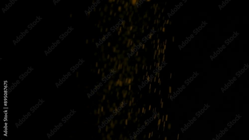 Abstract black background with a stream of slowly pouring orange turmeric powder. Abstract black background with a stream of slowly pouring orange turmeric powder.