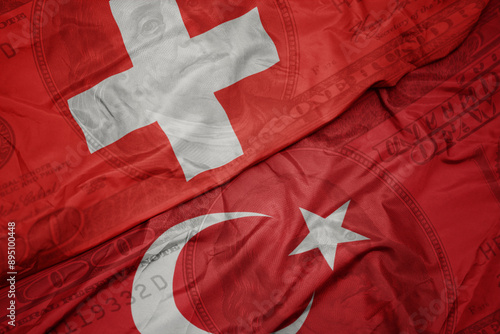 Fototapeta Naklejka Na Ścianę i Meble -  waving colorful flag of switzerland and national flag of turkey on the dollar money background. finance concept.