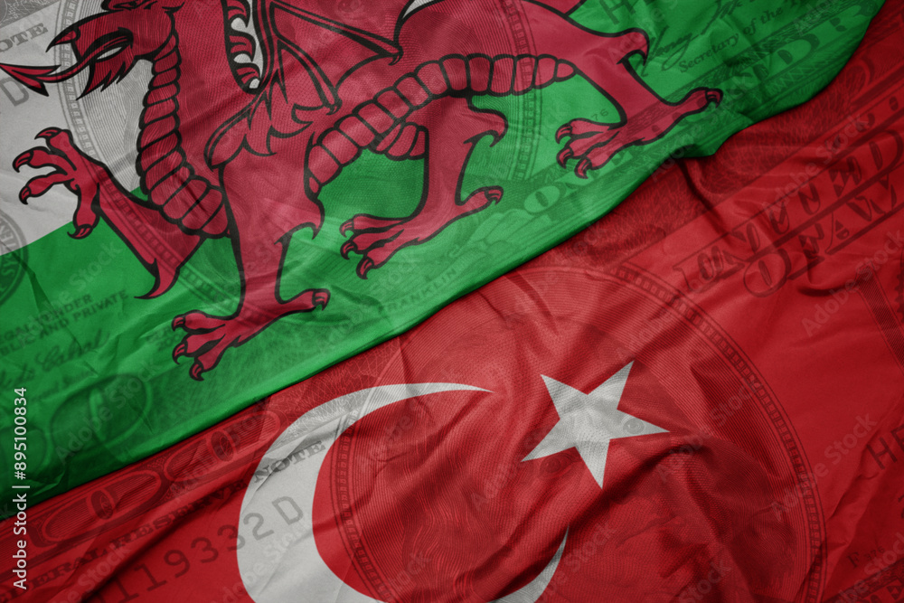 Φωτογραφία waving colorful flag of wales and national flag of turkey on the dollar money background