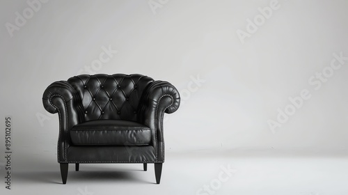 Black leather armchair on a white background. The armchair is classic in style with a tufted seat and back. photo