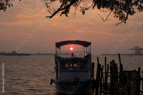 A sunset seen through a boat in a beach