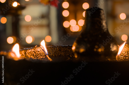A lit lamp flame in a temple