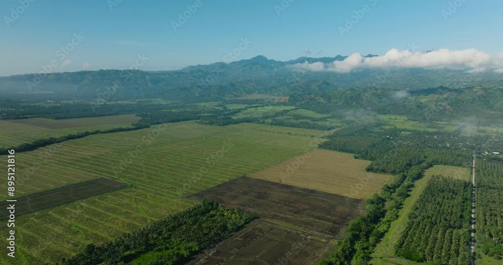 Top view of Agricultural Land with beautiful cloudscape and mountain view. Mindanao, Philippines. Top view of Agricultural Land with beautiful cloudscape and mountain view. Mindanao, Philippines.