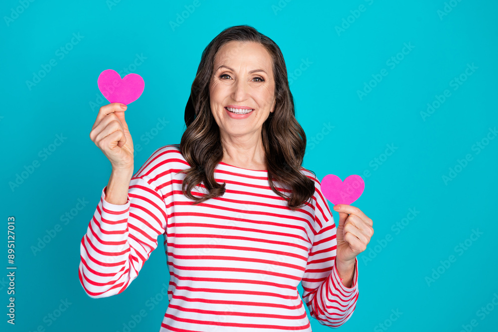Photo of nice aged woman hold small heart wear pullover isolated on teal color background Photo of nice aged woman hold small heart wear pullover isolated on teal color background