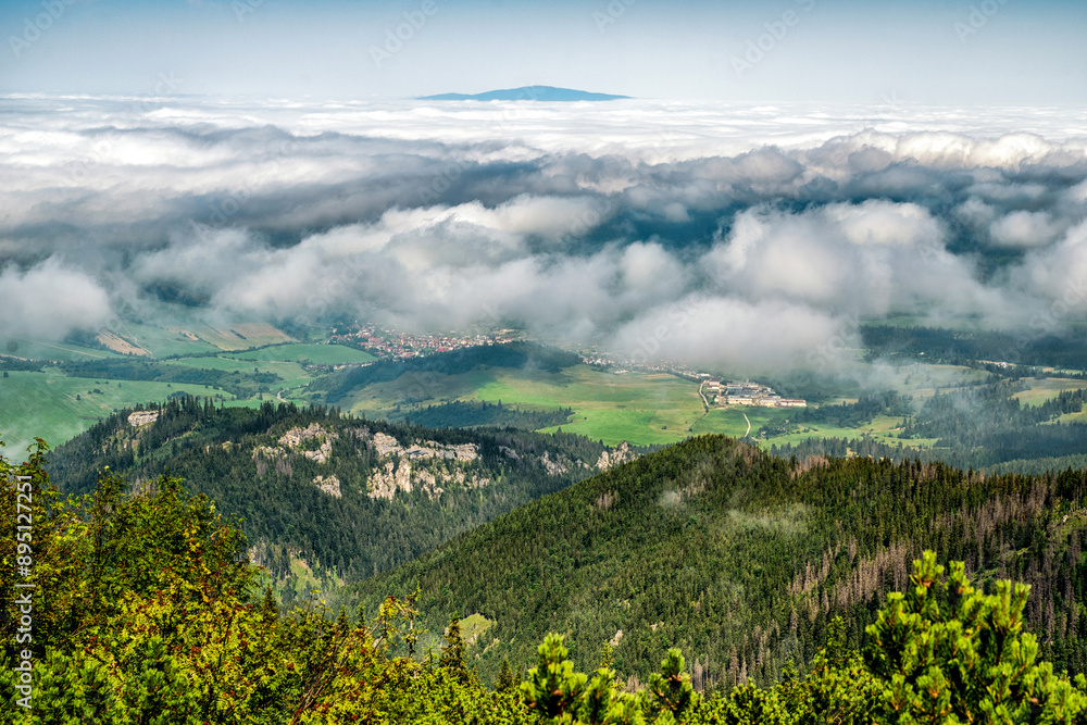 Fototapeta premium View from top of the hill Sivy vrch in Western Tatras at Slovakia through inversion. Hill Babia Hora at background