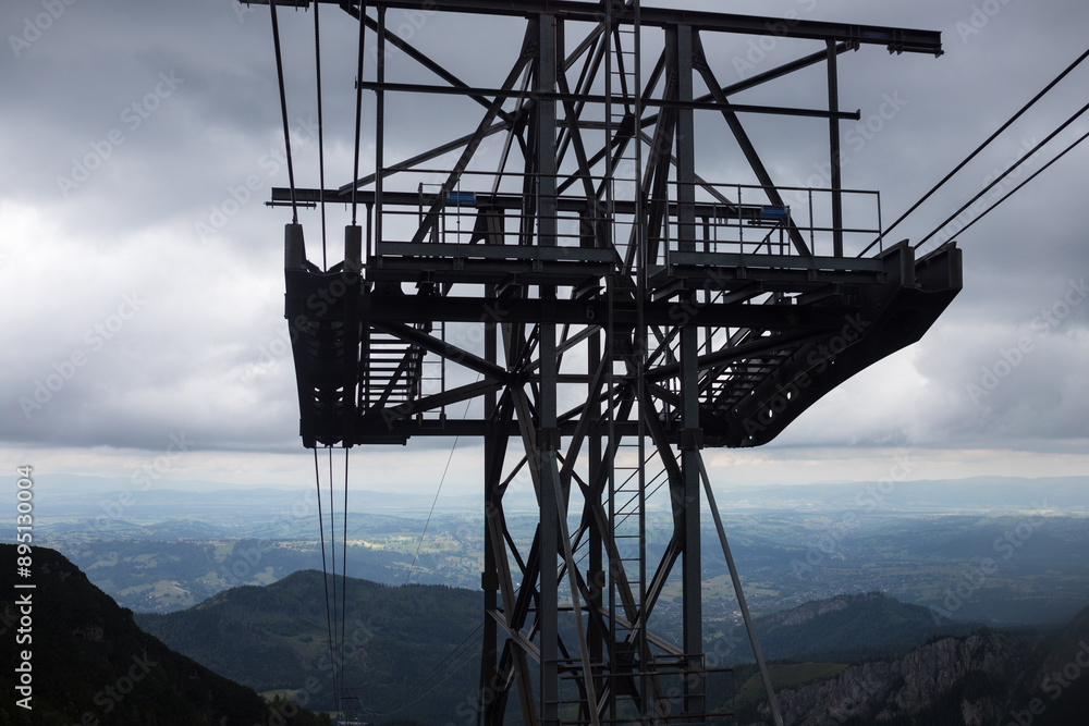 Funicular lift high in the mountains. Panorama of the mountains from the ski lift. Cables stretched from the mountain to the foot. Funicular structure high in the mountains. Funicular lift high in the mountains. Panorama of the mountains from the ski lift. Cables stretched from the mountain to the foot. Funicular structure high in the mountains.