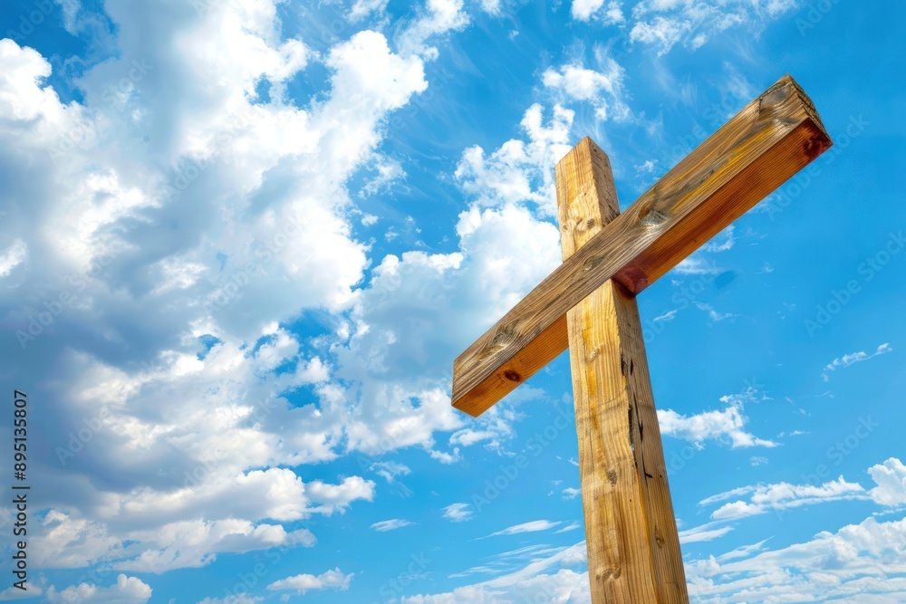 a wooden Christian cross against a blue sky with scattered clouds. Concept of Faith and Spirituality