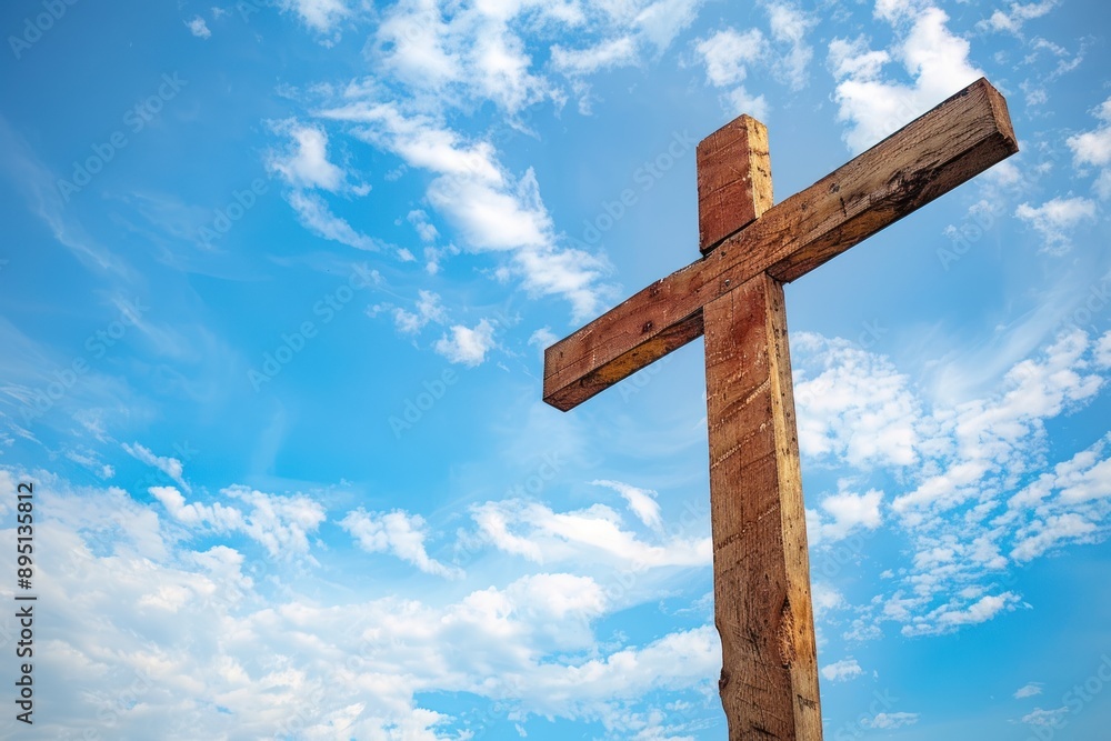 a wooden Christian cross against a blue sky with scattered clouds. Concept of Faith and Spirituality a wooden Christian cross against a blue sky with scattered clouds. Concept of Faith and Spirituality