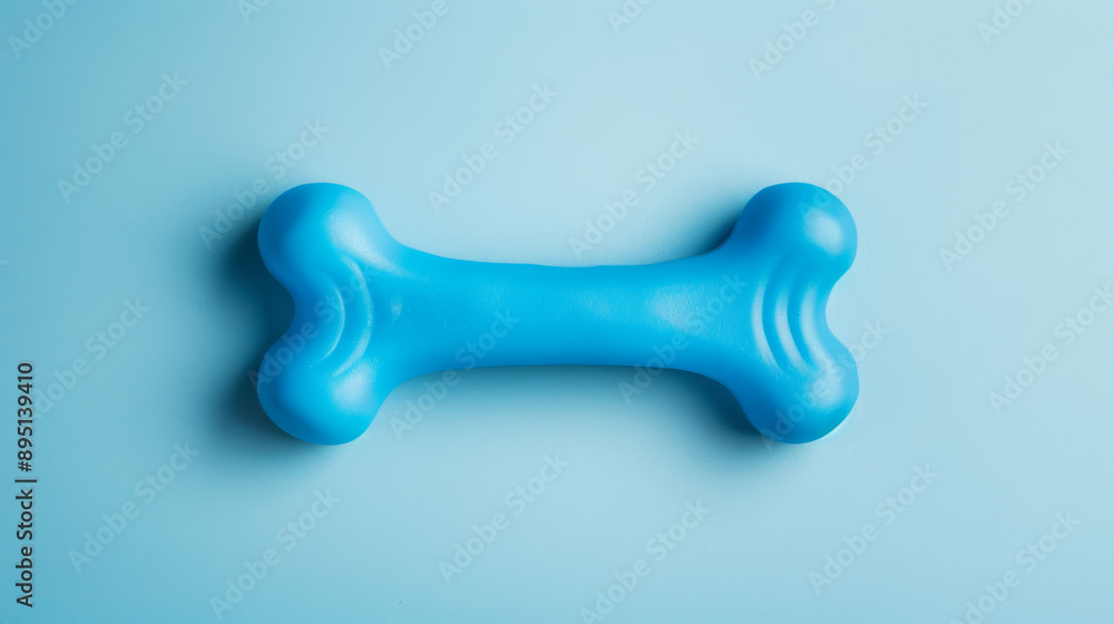 Isolated image of a bright blue chew toy shaped like a bone, on a gradient background Isolated image of a bright blue chew toy shaped like a bone, on a gradient background