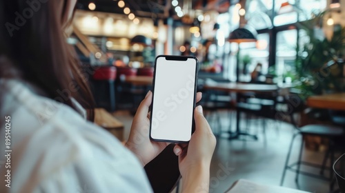 woman using cell phone in coffee shop
