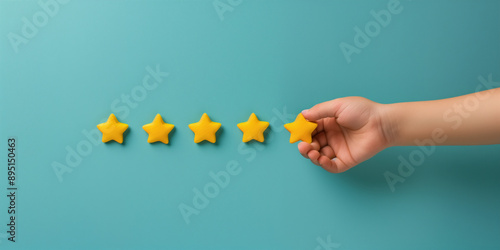 Hand giving five stars for good customer experience, yellow stars on blue background photo