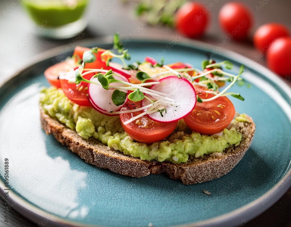 A rich and creamy avocado toast topped with cherry tomatoes, radish slices, and microgreens. A rich and creamy avocado toast topped with cherry tomatoes, radish slices, and microgreens.
