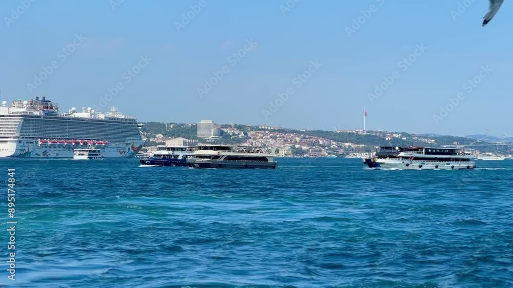 View of the Bosphorus. Small ships pass by in the Bosphorus, cruise ships are seen in the background. Ship traffic in the Bosphorus and the Bosphorus Bridge. View of the Bosphorus. Small ships pass by in the Bosphorus, cruise ships are seen in the background. Ship traffic in the Bosphorus and the Bosphorus Bridge.