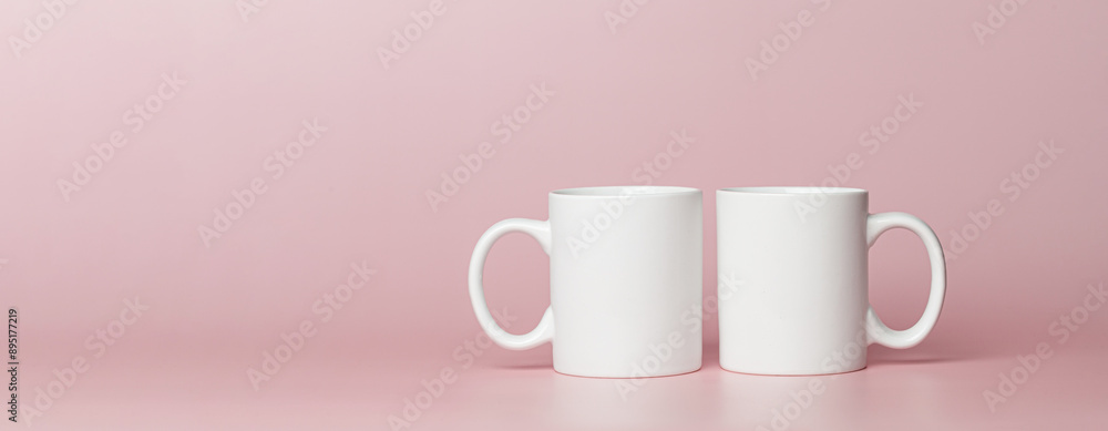 white cups for tea or coffee on a pink background white cups for tea or coffee on a pink background