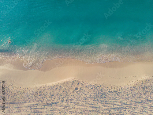 sand beach with waves from above 