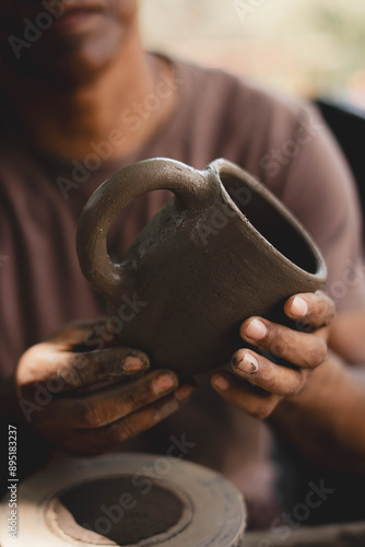 Costa Rican man crafting a Chorotega pottery mug.  photo