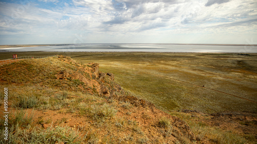 Vast Prairie Landscape with Wide Horizon, Cloudy Sky, evoking tranquility and natural beauty