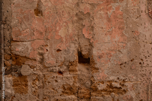 A weathered brick wall with...