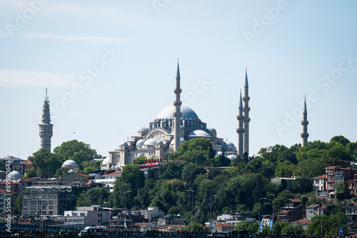 Fatih, Istanbul, Turkey - June 2024: Iconic View of Suleymaniye Mosque Amidst the Greenery and Urban Landscape of Istanbul photo